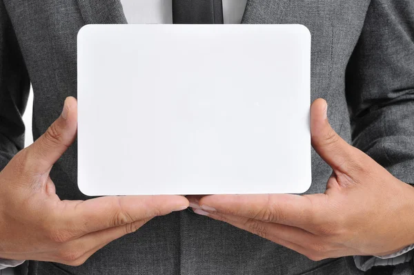 Man in suit holding a blank signboard — Stock Photo, Image