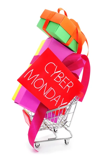 Gifts in a shopping cart and signboard with the text cyber monda — Stock Photo, Image