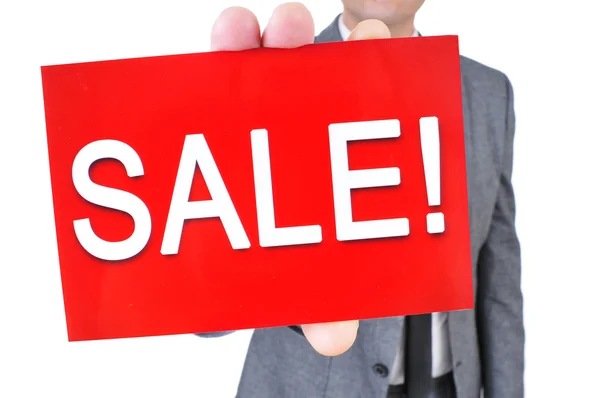 Man in suit with a signboard with the text sale — Stock Photo, Image