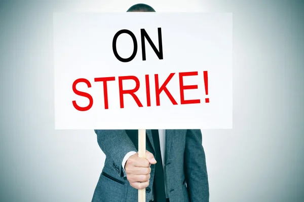 Young man in suit on strike — Stock Photo, Image