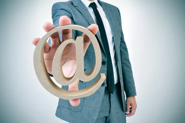 Geschäftsmann mit "at" -Schild — Stockfoto