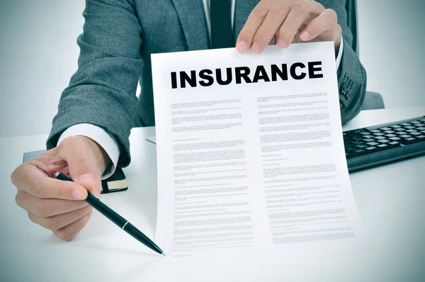 Young man in suit showing an insurance policy — Stock Photo, Image