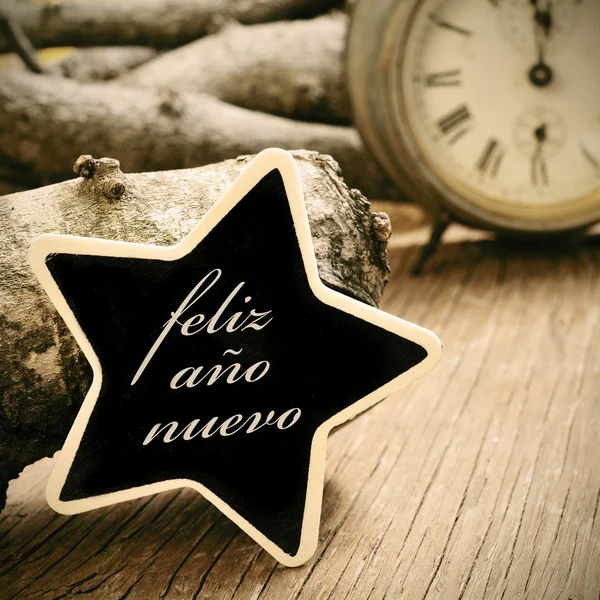 Feliz ano nuevo, happy new year in spanish, in a star-shaped cha — Stock Photo, Image