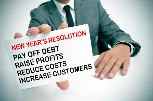 Businessman with a list of new years resolutions — Stock Photo, Image