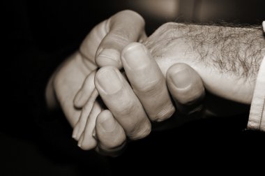 Young man holding the hand of an old man clipart