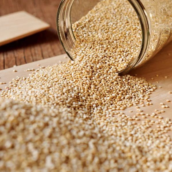 Quinoa seeds and jar — Stock Photo, Image