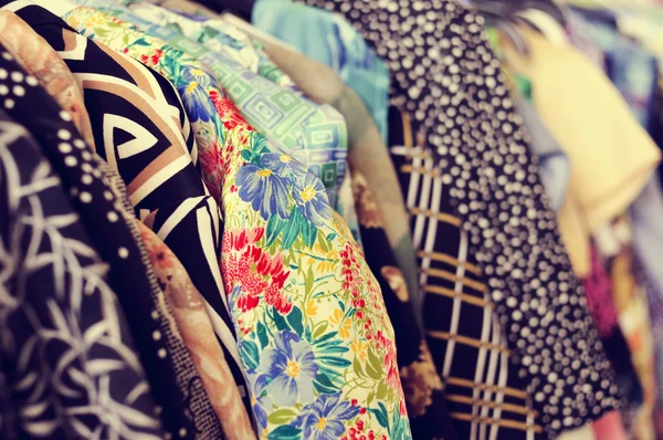 Clothes hanging on a rack in a flea market — Stock Photo, Image