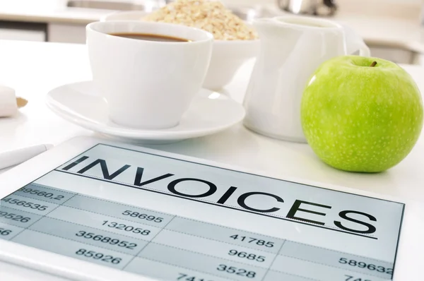 Breakfast and invoices on table — Stock Photo, Image