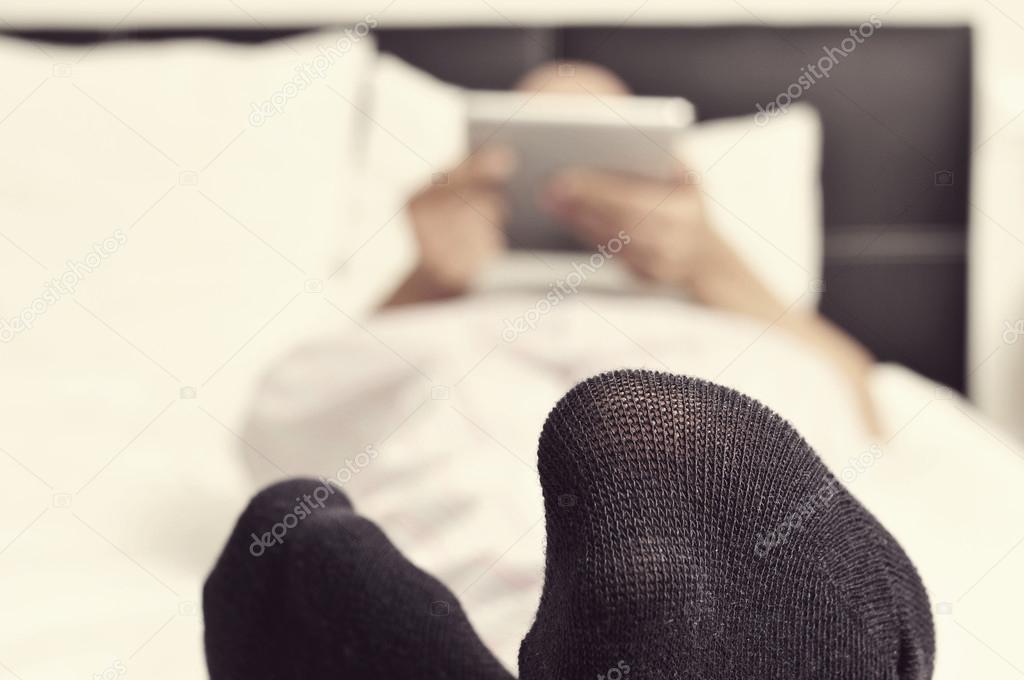 Man using a tablet in bed