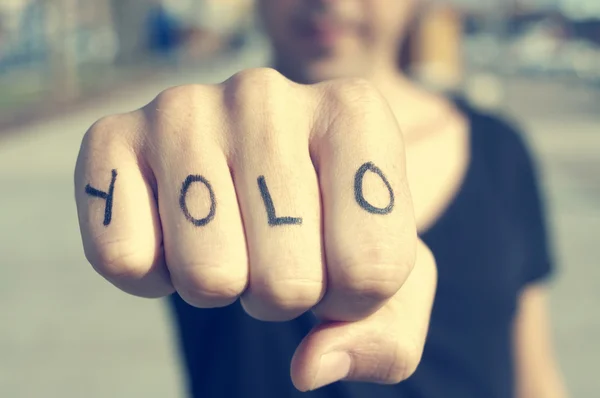 Young man with the word yolo — Stock Photo, Image