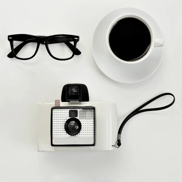 Eyeglasses, coffee and instant camera — Stock Photo, Image