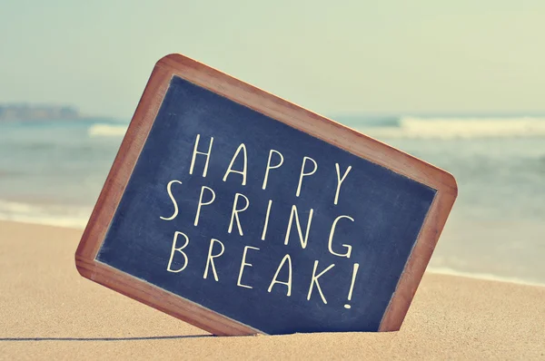 Happy spring break in a blackboard on the beach — Stock Photo, Image