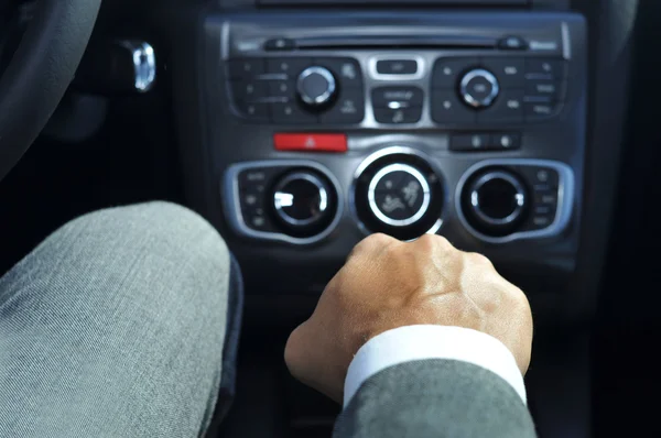 Young man in suit driving a car — Stock Photo, Image