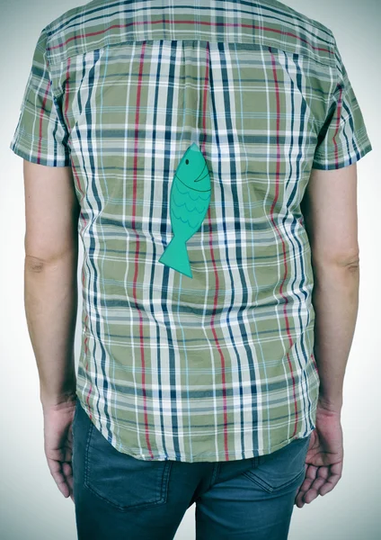 Young man with a paper fish attached to his back — Stock Photo, Image