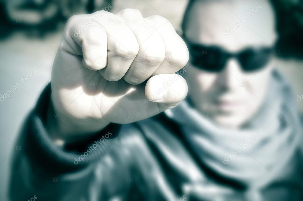 Young man in a protest raising his fist