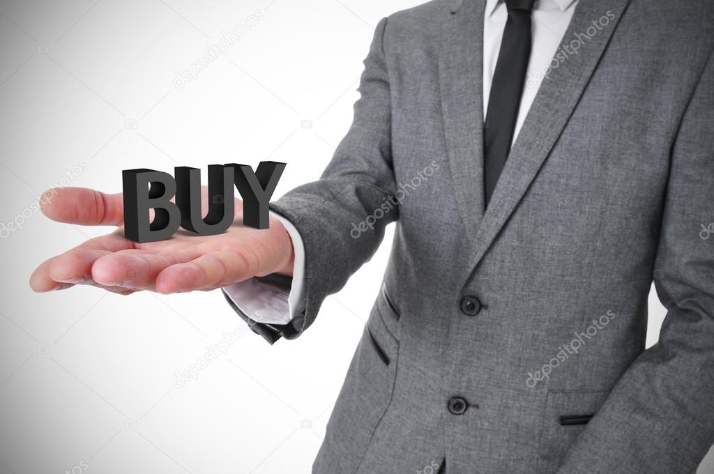 Businessman with the word buy in his hand