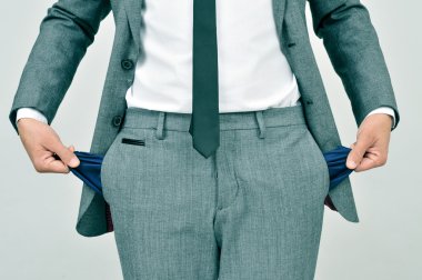 broke businessman showing his empty pockets clipart