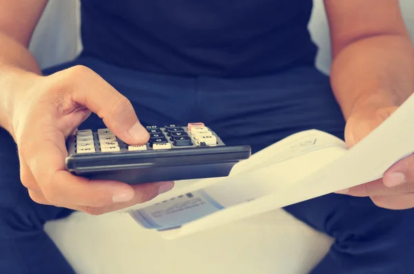 Young man checking a bill, a budget or a payroll — Stock Photo, Image