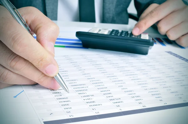 Young businessman checking accounts — Stock Photo, Image