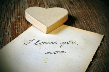I love you, mom written on an old sheet of paper, with a retro e clipart
