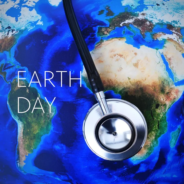 Stethoscope on a world map (furnished by NASA) and the text eart — Stock Photo, Image