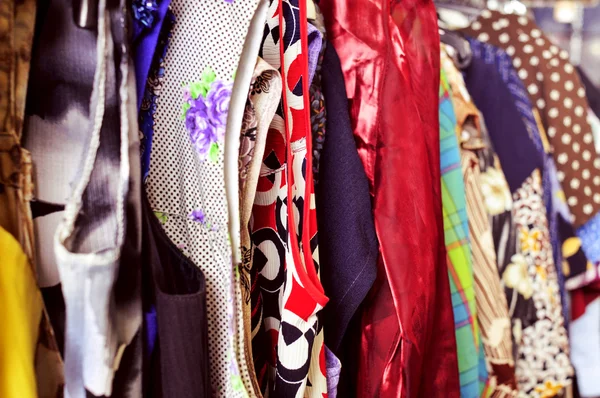 Clothes hanging on a rack in a flea market — Stock Photo, Image