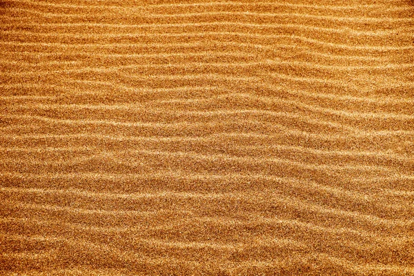 Zand achtergrond met een natuurlijke golvenpatroon — Stockfoto