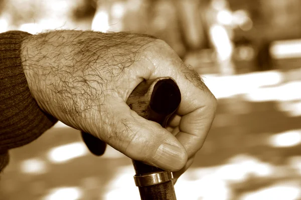 Old man with a walking stick, in sepia toning — Stock Photo, Image