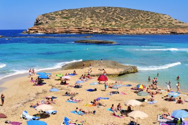 Sunbathers at Cala Conta beach in San Antonio, Ibiza Island
