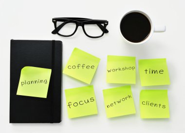 sticky notes with different work concepts on an office desk