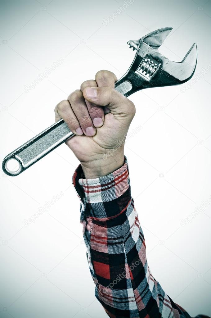 Man with adjustable wrench in his hand