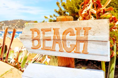 signpost pointing to the beach in Ibiza Island, Spain, with a fi