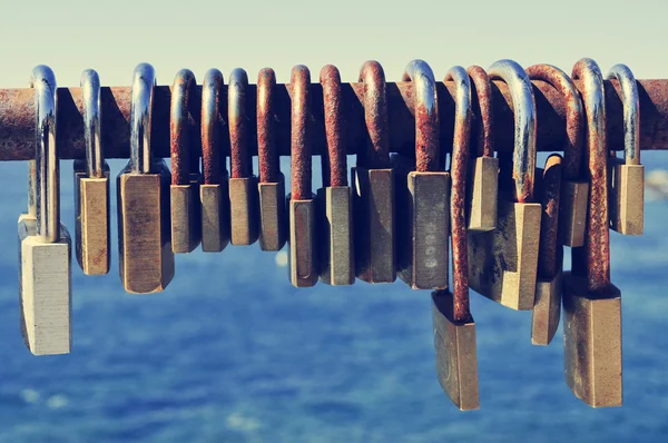 Rusty padlocks on a railing near the sea — Stock Fotó