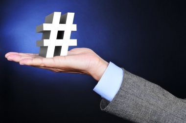 businessman with a 3D hash sign in his hand