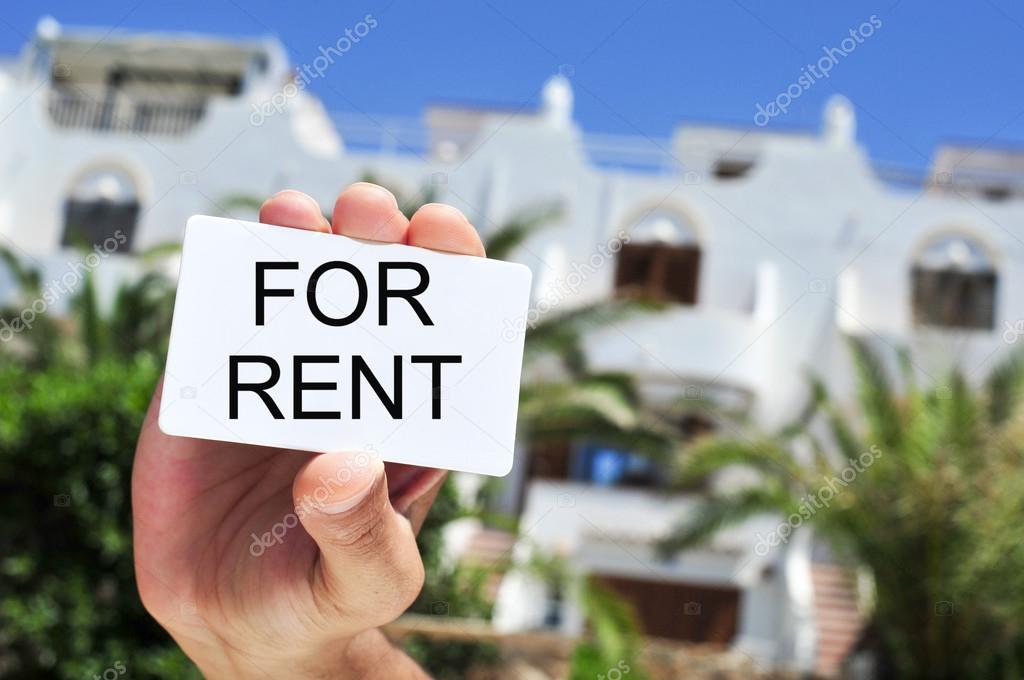 man holding a signboard with the text for rent