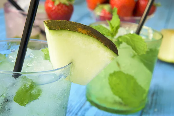 Refreshing melon mojito on a rustic blue table — Stok fotoğraf