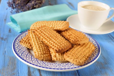 homemade cookies and cup of coffee on a rustic blue table