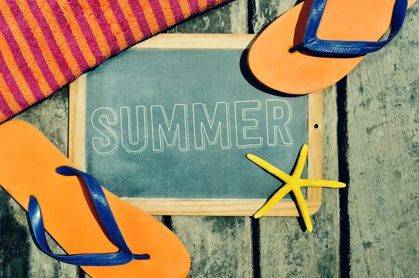 Flip-flops, starfish and chalkboard with the word summer — Stockfoto