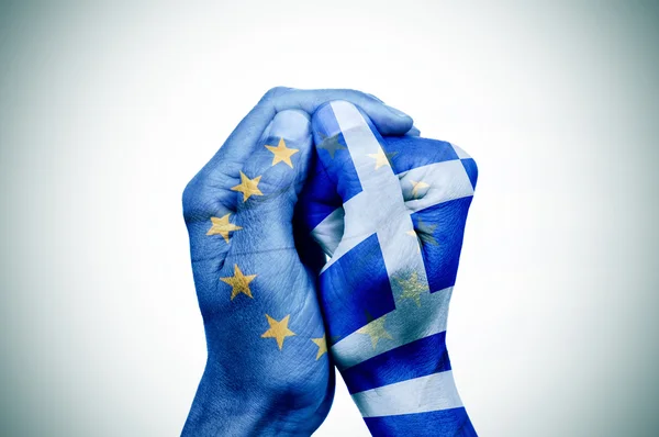 Mãos modeladas com a bandeira europeia e grega juntas — Fotografia de Stock