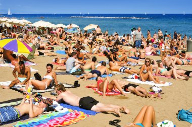 sunbathers at La Barceloneta Beach, in Barcelona, Spain clipart