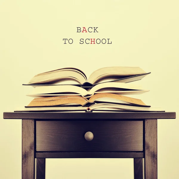 Open books on a table and text back to school, with a retro effe — Stock Photo, Image