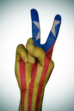 V sign patterned with the Catalan pro-independence flag clipart