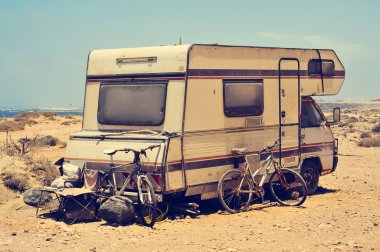 Aged motorhome close to the sea clipart