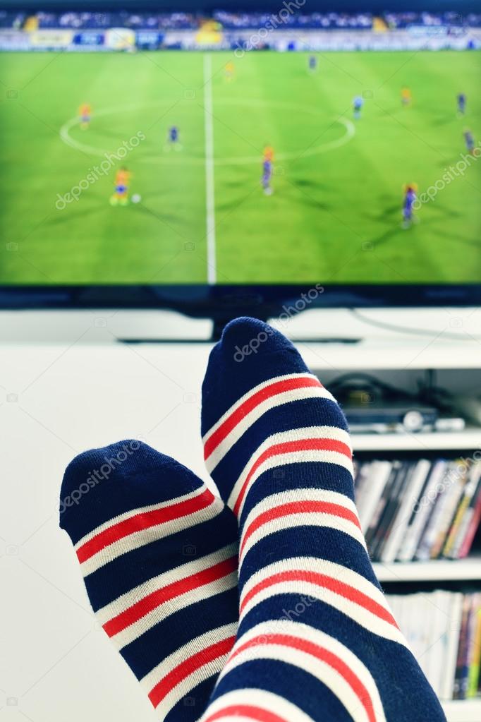 man watching a soccer match in the TV