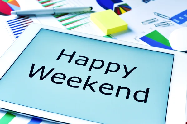 Text happy weekend in the screen of a tablet — Stock Photo, Image