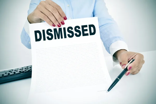 Businesswoman shows a document with the text dismissed — Stock Photo, Image