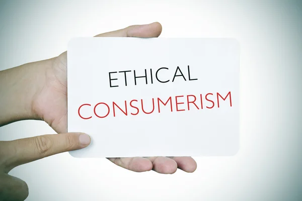 Man with a signboard with the text ethical consumerism — Stock Photo, Image