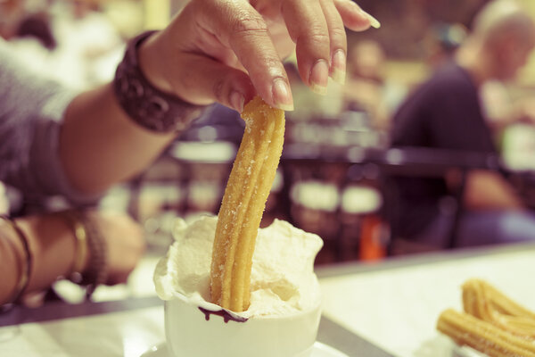 churros and hot chocolate topped with whipped cream