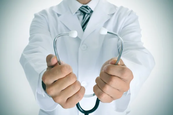 Young doctor man with a stethoscope, vignetted Stock Image