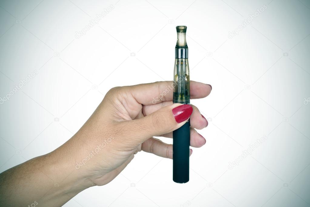 young woman showing an electronic cigarette, vignetted